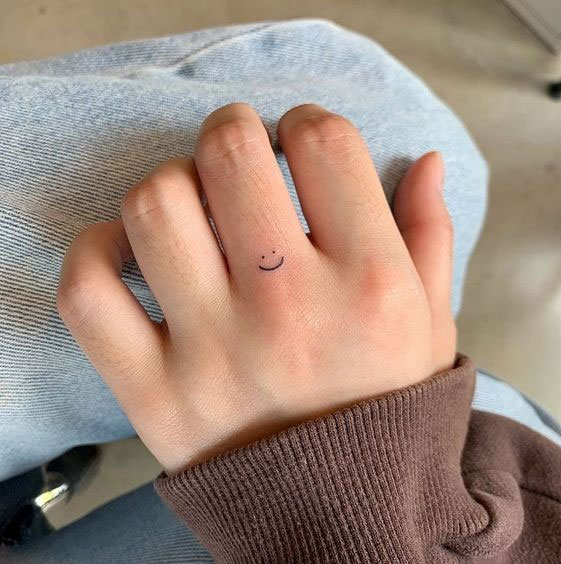 smiley tattoo finger