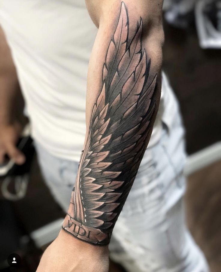 wings on forearm tattoo