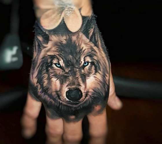 realistic wolf hand tattoo